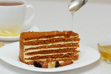 honey cake on a plate with nuts and tea for dessert