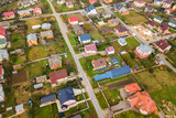 Fototapeta Miasto - Aerial view of home roofs in residential rural neighborhood area.