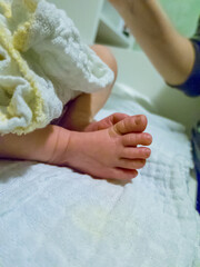 Canvas Print - Vertishot of newborn's foot on white cloth