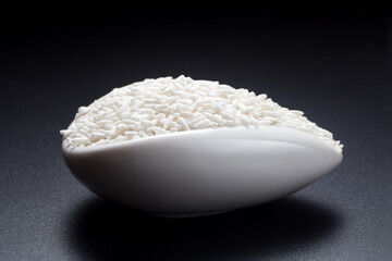 Wall Mural - Glutinous rice in a ceramic spoon on black background.