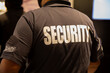 © Flex_Point_Security - Rear view of security guard in uniform patrolling in commercial mall