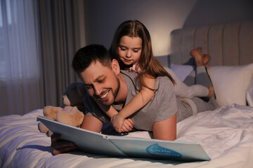 Sticker - Father with his daughter reading book in bed at home