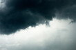 © morkdam - Dramatic dark grey clouds sky with storm and rain.