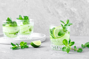 Wall Mural - Mint, lime and cucumber refreshing infused detox cocktail with ice, light refreshment summer mocktail