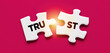 Two puzzle pieces with the word Trust. Broken trust, to violate agreements, to lose credibility and reputation