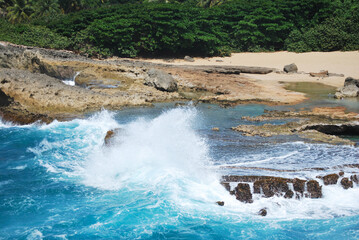 A wave breaking in a rock on the beach 