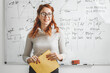 © BalanceFormCreative - Portrait of red hair female professor. She lecture about new technologies and software development.