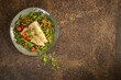 Alaskan pollock fillet with steamed green beans on a rusty metal background with copy space, top view