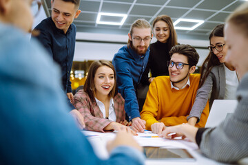 Business colleagues working together in creative office. Young people discuss financial result review paperwork share ideas brainstorm collaborate work in teamwork. Planning, analysis.