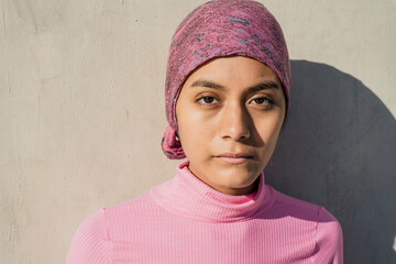 Close-up of a young woman with cancer showing sadness and concern on her face. Concept Medical treatment, cancer, depression.