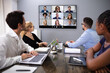 Businesspeople Discussing Graphs Through Videochat