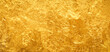 Shiny gold background made of rough textured gold leaf.