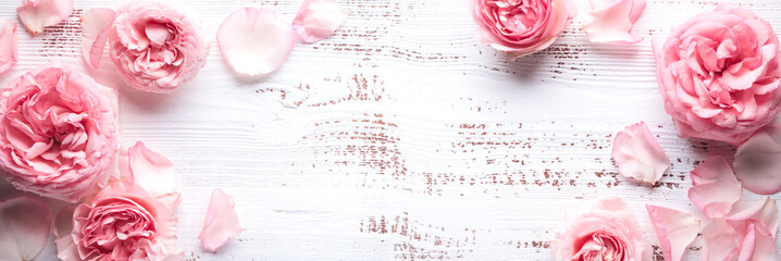 Wall Mural - Flowers composition. Rose flower petals on wooden background