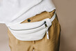 White Leather Fanny Pack, Cell Phone Belt Pouch. Selective focus. Blurred background.