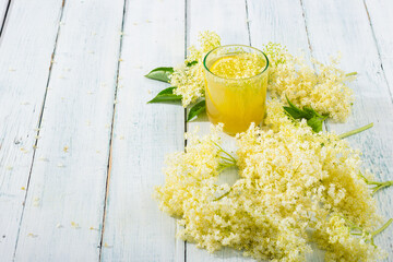 Wall Mural - organic refreshment juice from elderberry blossom on white wooden table