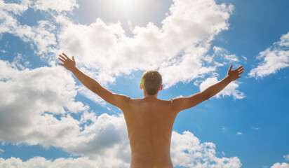 Wall Mural - Man strive hands to the deep blue sky and sun.