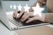 © Vittaya_25 - 5 star rating. business woman hand working on laptop with five star button on visual screen to review good rating, digital marketing, good experience, positive thinking and customer feedback concept
