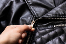 Hand Unbuttones Lock Of Black Leather Jacket