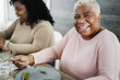 © DisobeyArt - Happy black family eating lunch at home - Mother and daughter, having fun together sitting at dinner table - Focus on mother face