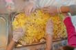 Cooking pizza, children's hands in gloves for cooking, lay out ingredients