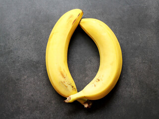 Two ripe bananas on a black background