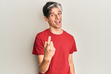 Sticker - Young hispanic man wearing casual clothes beckoning come here gesture with hand inviting welcoming happy and smiling