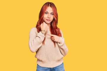 Sticker - Young redhead woman wearing casual winter sweater in hurry pointing to watch time, impatience, looking at the camera with relaxed expression