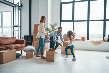 Happy young family smiling and unboxing their stuff 