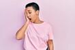 © Krakenimages.com - Beautiful hispanic woman with short hair wearing casual pink t shirt yawning tired covering half face, eye and mouth with hand. face hurts in pain.