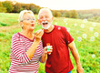 © Lumos sp - woman man outdoor senior couple happy fun retirement together bubble soap blowing love old nature mature