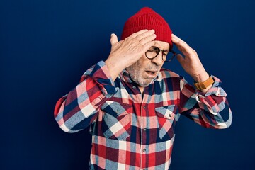 Canvas Print - Handsome mature man wearing hipster look with wool cap with hand on head for pain in head because stress. suffering migraine.