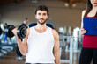 © Minerva Studio - Man working out in a gym with his personal trainer