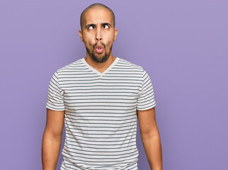 Poster - Hispanic adult man wearing casual clothes making fish face with lips, crazy and comical gesture. funny expression.