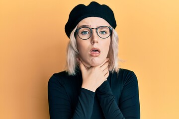 young blonde girl wearing french look with beret shouting and suffocate because painful strangle. he