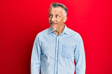 Poster - Middle age grey-haired man wearing casual clothes smiling looking to the side and staring away thinking.