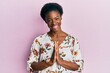 © Krakenimages.com - Young african american girl wearing casual clothes praying with hands together asking for forgiveness smiling confident.
