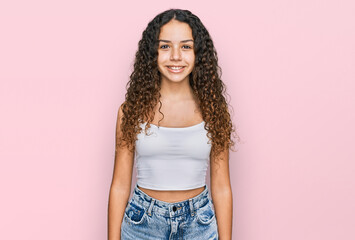 Teenager hispanic girl wearing casual clothes with a happy and cool smile on face. lucky person.