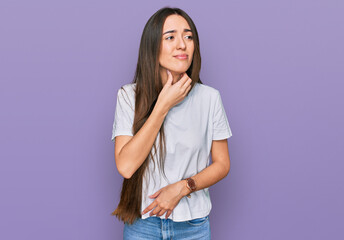 Wall Mural - Young hispanic girl wearing casual white t shirt touching painful neck, sore throat for flu, clod and infection