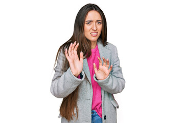 Sticker - Young hispanic girl wearing business clothes disgusted expression, displeased and fearful doing disgust face because aversion reaction. with hands raised