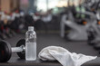© amnaj - Water bottle and a towel placed on a chair in the gym.