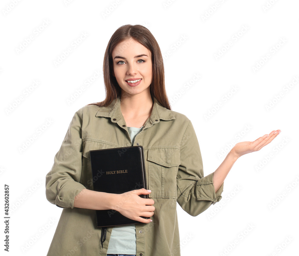Young woman with Bible on white background