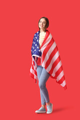 Wall Mural - Beautiful young woman with USA flag on color background