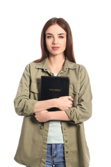 Wall Mural - Young woman with Bible on white background