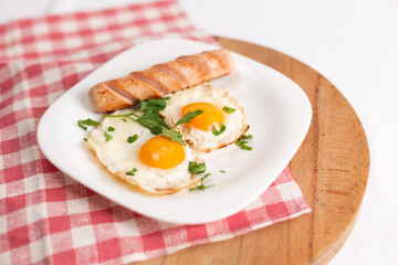 filipino silog breakfast with garlic fried rice, longsilog, and two sunny side up eggs