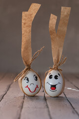 Wall Mural - easter white eggs with painted faces, family of eggs, three in one basket