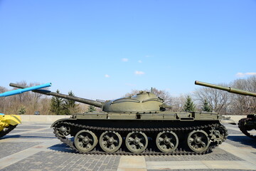 KYIV, UKRAINE - APRIL 10, 2019: Three main battle tanks in front of motherland monument in the World War 2 Museum in Kiev, Ukraine