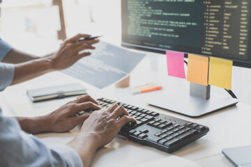 Wall Mural - programming developing software application. programmer writing program code with two monitors and w