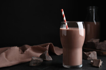 Delicious chocolate milk on black table. Space for text