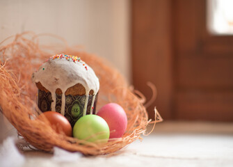 Easter cake and colorful eggs on the window