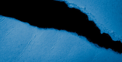 blue piece of paper on black isolated background